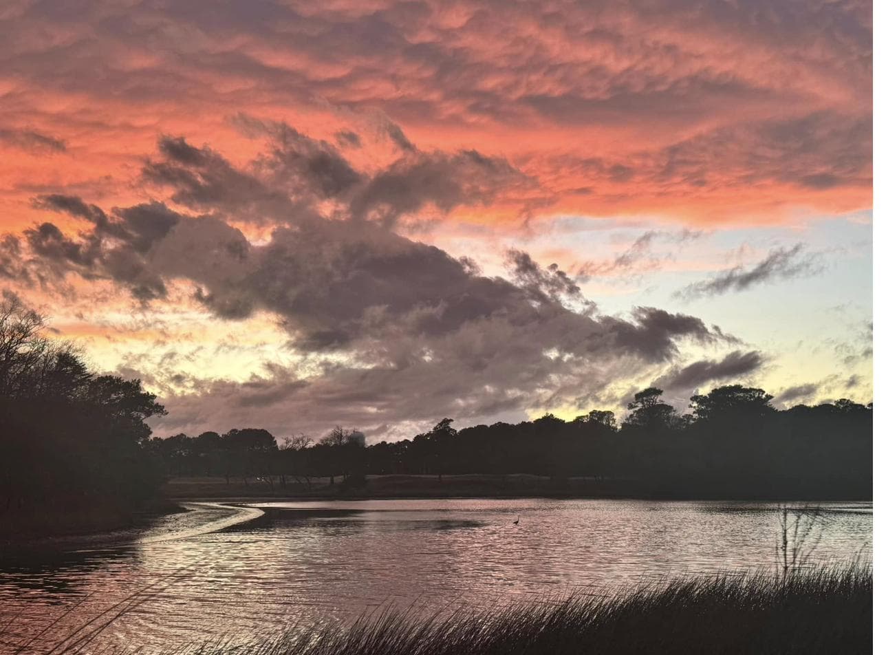 Painterly pink and peach sunset clouds over a Shore Drive marsh